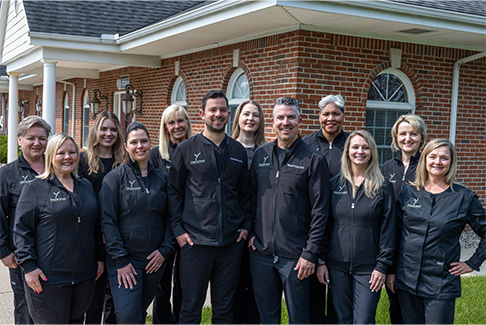 Dental team members standing in front of Forever Young Dentistry Bayside