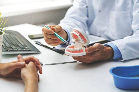 A patient consulting with their dentist about a treatment