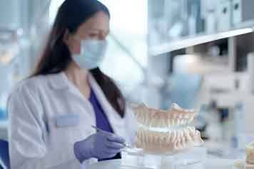 a lab technician working on creating new dentures