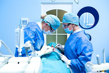 A dental team performing a dental implant surgery