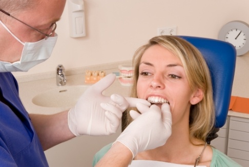 Dentist fitting a patient with an Invisalign clear aligner