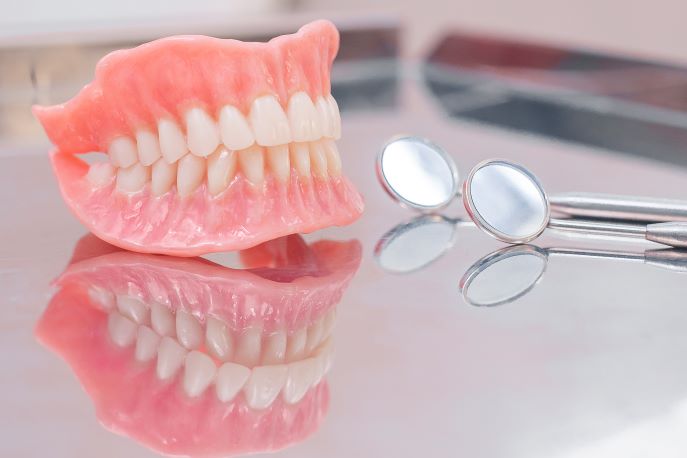 A pair of dentures and dental tools.